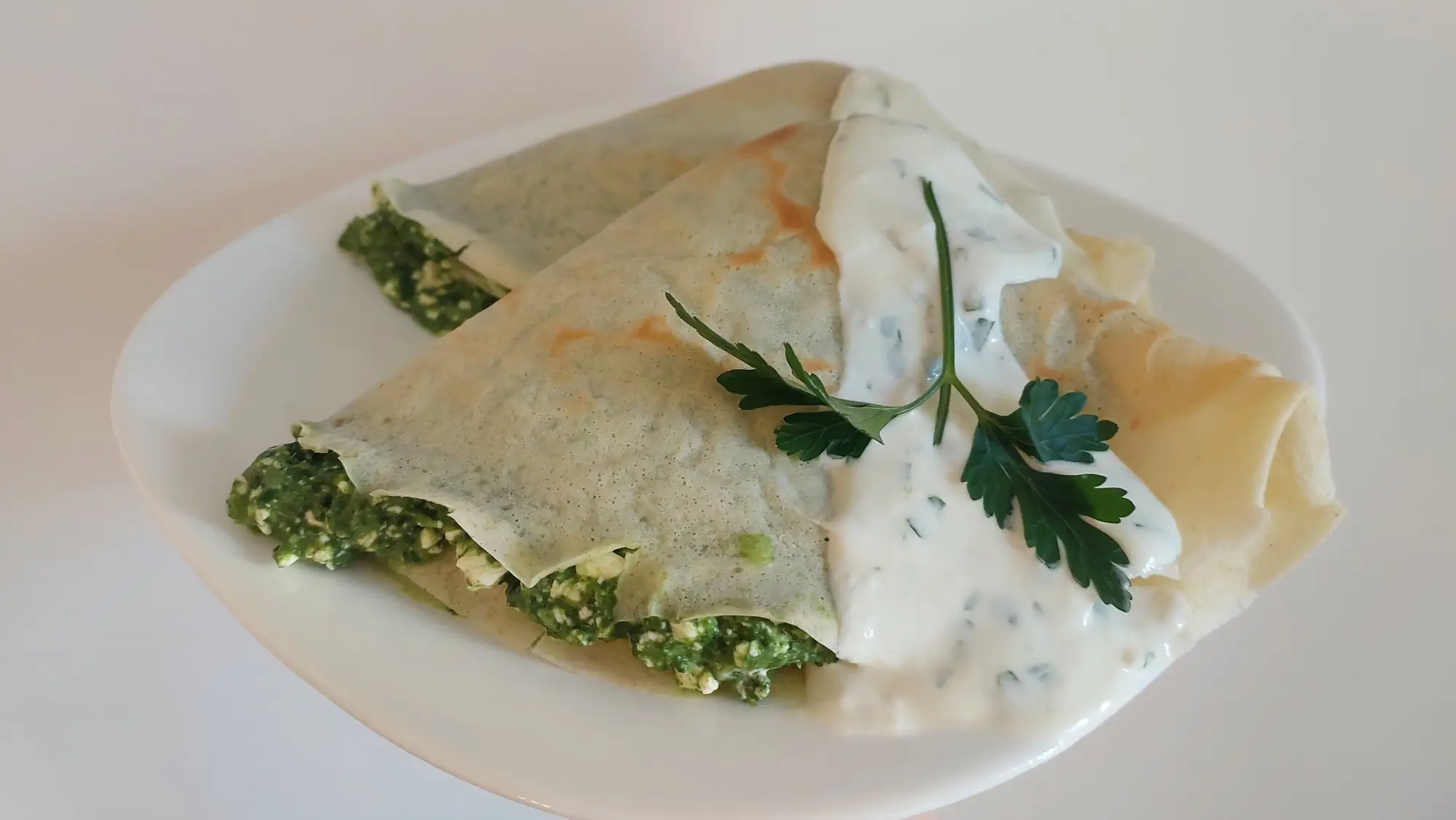 Naleśniki z serem, szpinakiem i sosem pietruszkowym
